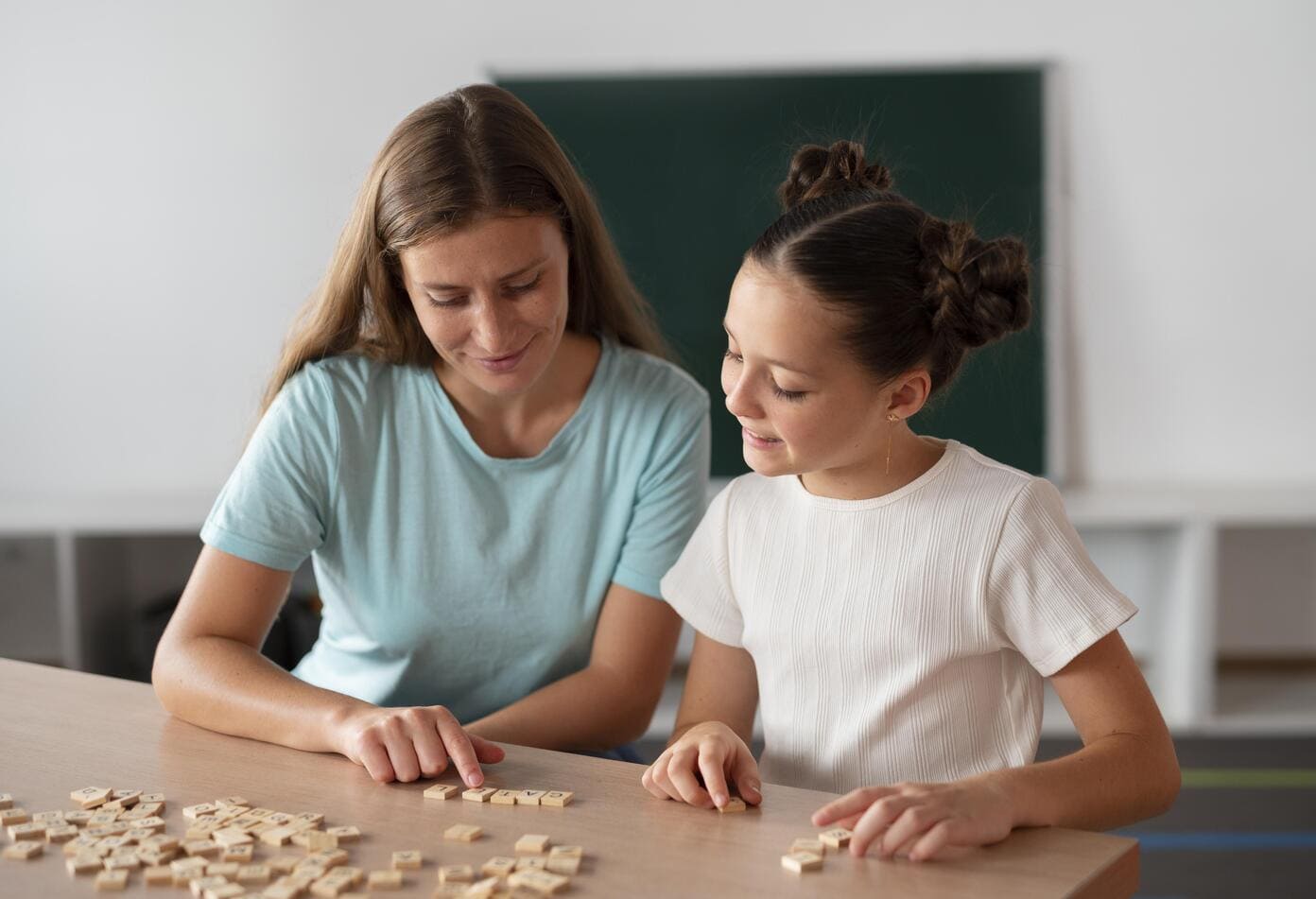 psychologist helping girl in speech therapy